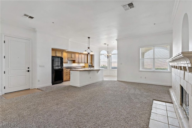 12 Strada Di Circolo -, Unit Henderson, NV 89011 - kitchen featuring freestanding refrigerator, crown molding, open floor plan, light colored carpet, and a chandelier