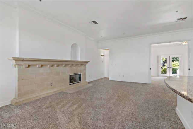 12 Strada Di Circolo -, Unit Henderson, NV 89011 - unfurnished living room featuring ornamental molding, carpet flooring, a tile fireplace, baseboards, and ceiling fan