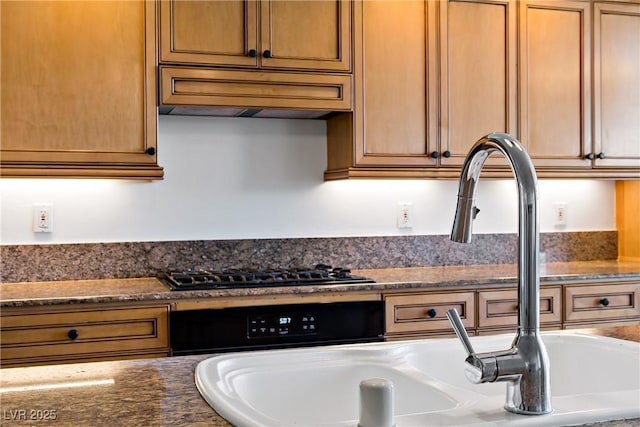 12 Strada Di Circolo -, Unit Henderson, NV 89011 - kitchen with dark stone counters, black gas stovetop, and built in desk