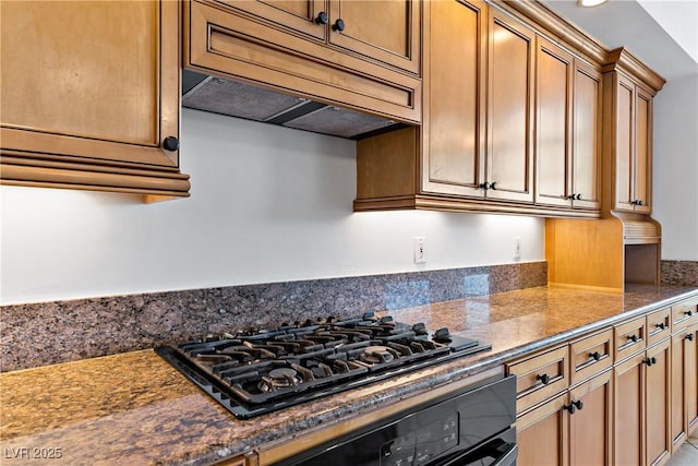 12 Strada Di Circolo -, Unit Henderson, NV 89011 - kitchen featuring black gas stovetop, oven, premium range hood, and brown cabinetry
