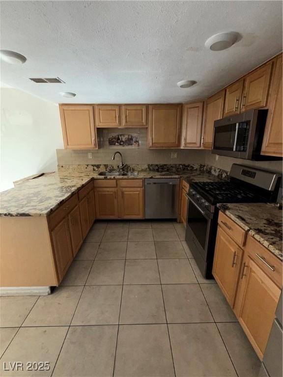 6521 Sugarpine Ln, Las Vegas, NV 89107 - kitchen featuring stainless steel appliances, a sink, light stone counters, light tile patterned flooring, and a textured ceiling