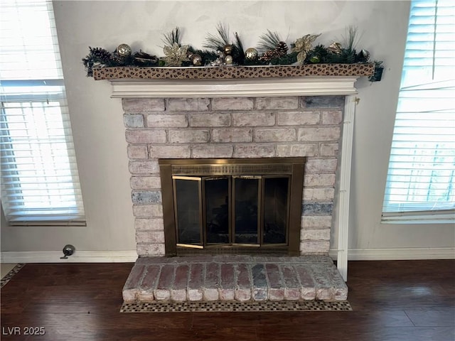 6521 Sugarpine Ln, Las Vegas, NV 89107 - detailed view of a fireplace, baseboards, and wood finished floors