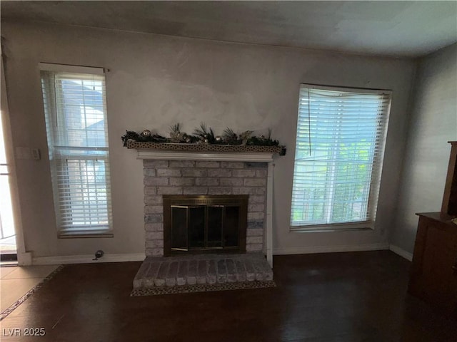 6521 Sugarpine Ln, Las Vegas, NV 89107 - unfurnished living room featuring baseboards, a fireplace, and plenty of natural light