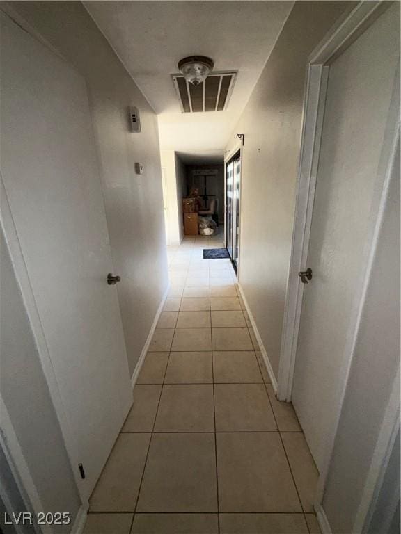 6521 Sugarpine Ln, Las Vegas, NV 89107 - hallway with light tile patterned flooring and baseboards