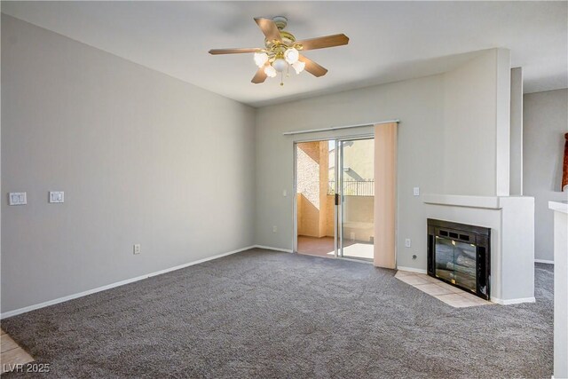 8501 W University Ave Unit 2020, Las Vegas, NV 89147 - unfurnished living room featuring a ceiling fan, carpet flooring, a fireplace with flush hearth, and baseboards
