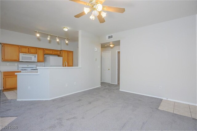8501 W University Ave Unit 2020, Las Vegas, NV 89147 - kitchen featuring white microwave, range, fridge, light colored carpet, and light countertops