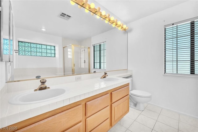 1951 Moyer Dr, Henderson, NV 89074 - bathroom featuring double vanity, tile patterned floors, a stall shower, and toilet
