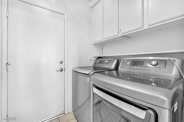 1951 Moyer Dr, Henderson, NV 89074 - laundry area with cabinet space, washer and clothes dryer, and light tile patterned floors