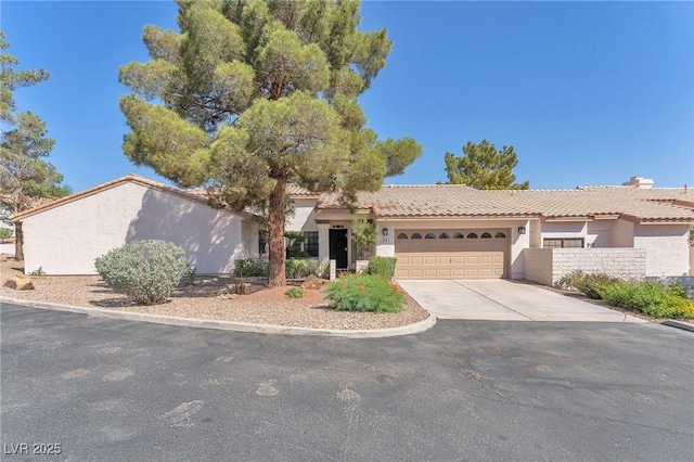1951 Moyer Dr, Henderson, NV 89074 - view of front of property featuring stucco siding, a garage, driveway, and a tile roof