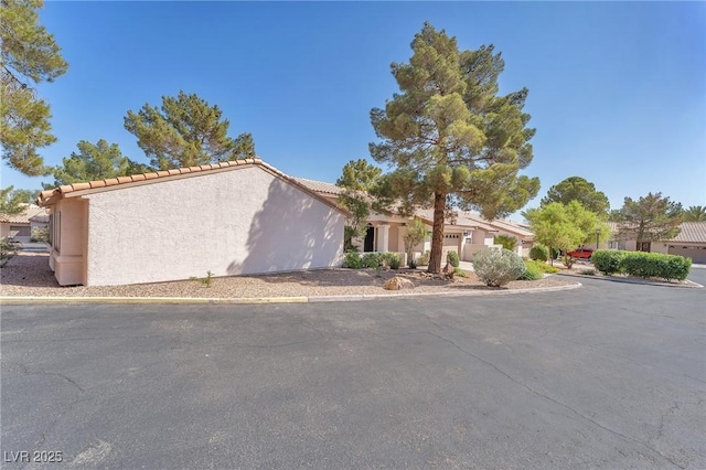 1951 Moyer Dr, Henderson, NV 89074 - view of front of house with stucco siding and a tiled roof