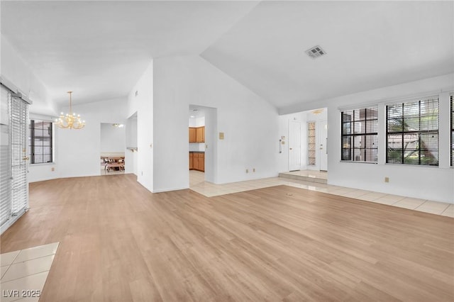 1951 Moyer Dr, Henderson, NV 89074 - unfurnished living room featuring a chandelier, light wood-type flooring, and high vaulted ceiling