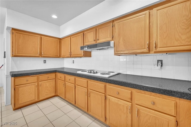 1951 Moyer Dr, Henderson, NV 89074 - kitchen featuring under cabinet range hood, white electric stovetop, backsplash, and dark countertops