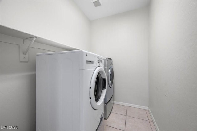 4062 Vulcan St, Las Vegas, NV 89122 - laundry room with separate washer and dryer and light tile patterned floors
