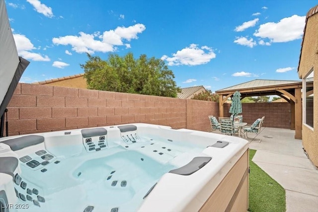 4062 Vulcan St, Las Vegas, NV 89122 - fenced backyard with a gazebo, a hot tub, and a patio