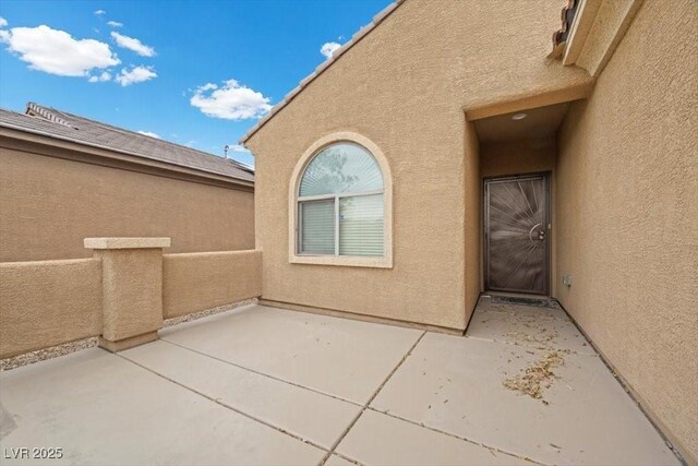 4062 Vulcan St, Las Vegas, NV 89122 - entrance to property featuring stucco siding and a patio