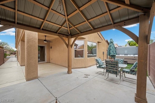 4062 Vulcan St, Las Vegas, NV 89122 - view of patio featuring outdoor dining space, a ceiling fan, a gazebo, and a gate