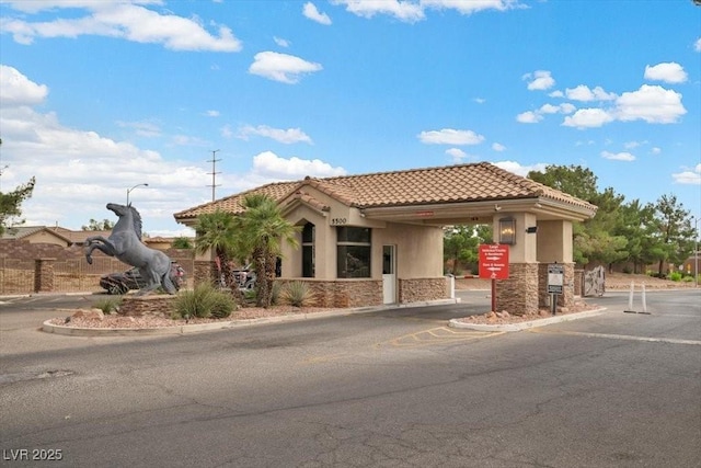 4062 Vulcan St, Las Vegas, NV 89122 - view of front of home featuring stone siding, driveway, stucco siding, a tiled roof, and a carport