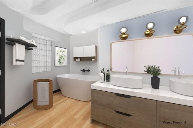 60 Innisbrook Ave, Las Vegas, NV 89113 - bathroom featuring wood finished floors, a freestanding bath, and double vanity