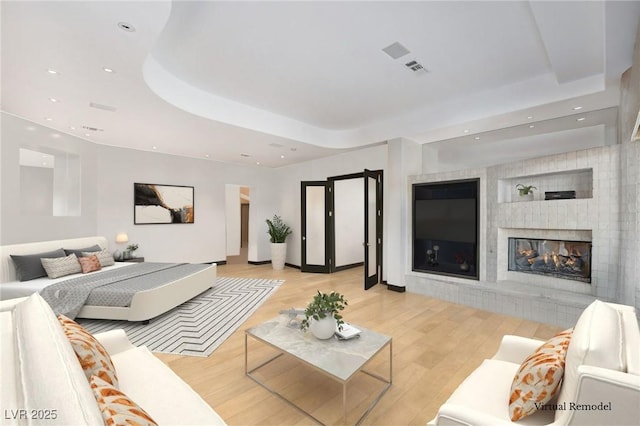 60 Innisbrook Ave, Las Vegas, NV 89113 - living area with a raised ceiling, light wood-style flooring, a multi sided fireplace, and recessed lighting