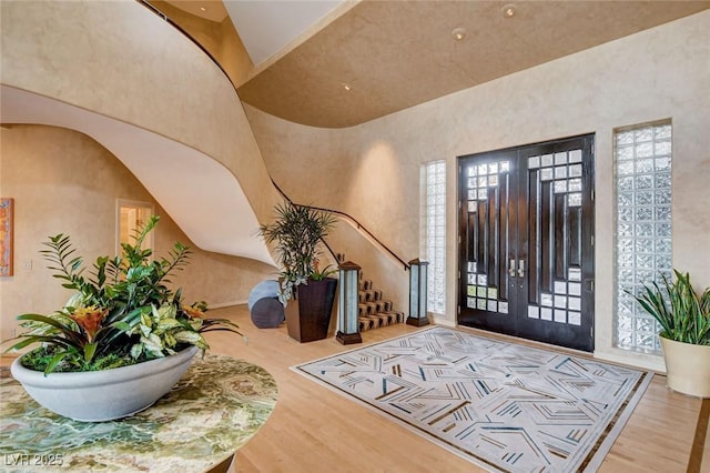60 Innisbrook Ave, Las Vegas, NV 89113 - entryway with wood finished floors, stairs, a high ceiling, and arched walkways