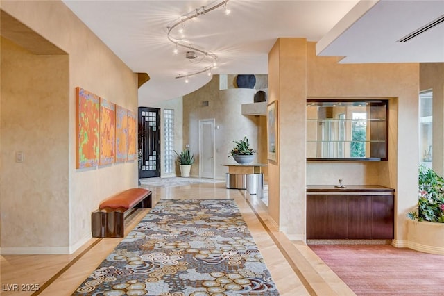 60 Innisbrook Ave, Las Vegas, NV 89113 - hallway featuring track lighting, light wood finished floors, and baseboards