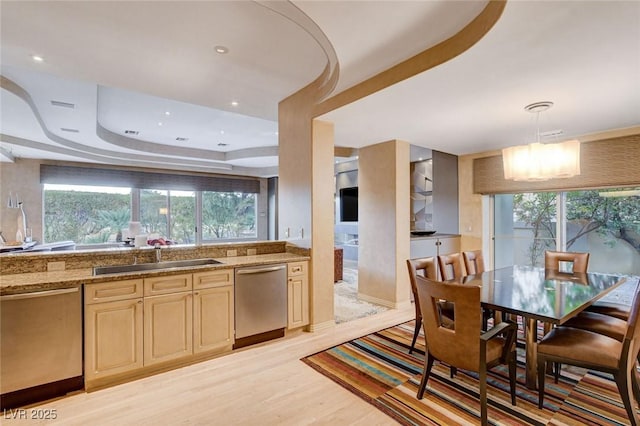 60 Innisbrook Ave, Las Vegas, NV 89113 - kitchen featuring dishwasher, a sink, a raised ceiling, and light wood-type flooring