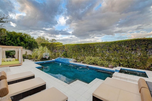 60 Innisbrook Ave, Las Vegas, NV 89113 - view of pool with a pool with connected hot tub, a fenced backyard, and an outdoor hangout area