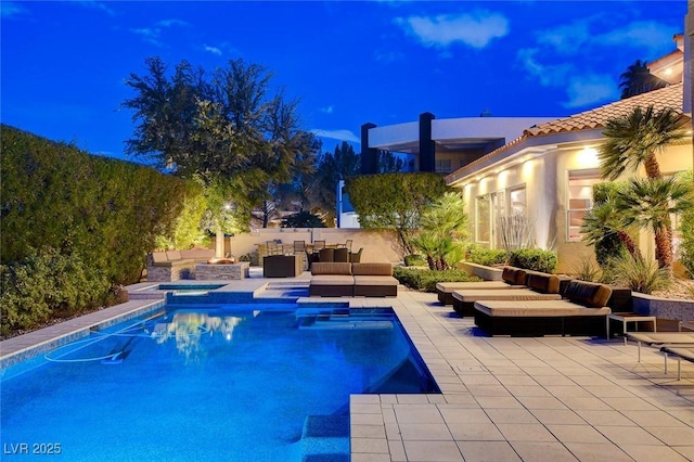 60 Innisbrook Ave, Las Vegas, NV 89113 - pool at twilight with an outdoor living space, a patio area, and a pool with connected hot tub