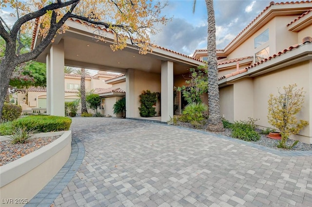 60 Innisbrook Ave, Las Vegas, NV 89113 - view of home's exterior with stucco siding, decorative driveway, and a tiled roof