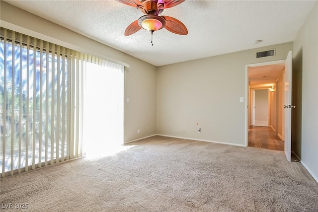 2614 Capistrano Ave, Las Vegas, NV 89121 - spare room featuring carpet, a ceiling fan, a textured ceiling, baseboards, and a smoke detector