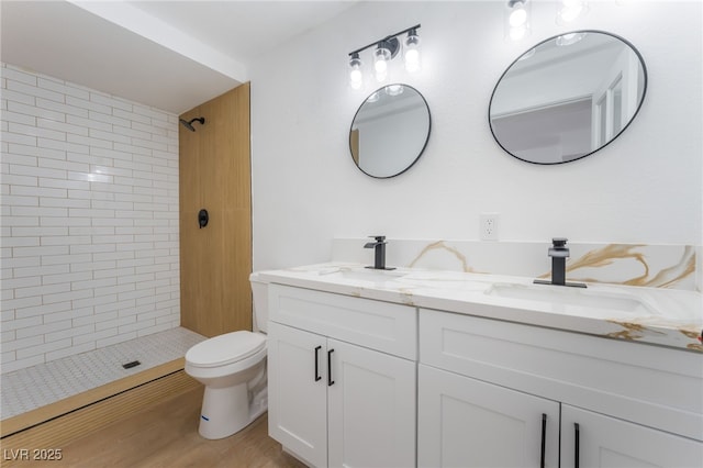 517 N 22nd St, Las Vegas, NV 89101 - full bath featuring double vanity, tiled shower, toilet, and wood finished floors