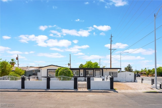 517 N 22nd St, Las Vegas, NV 89101 - view of front of home with a fenced front yard, a gate, and stucco siding