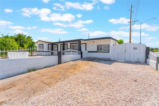 517 N 22nd St, Las Vegas, NV 89101 - view of front of home with a fenced front yard, a gate, and stucco siding