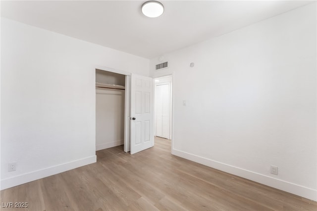 517 N 22nd St, Las Vegas, NV 89101 - unfurnished bedroom with baseboards, a closet, and light wood-style flooring