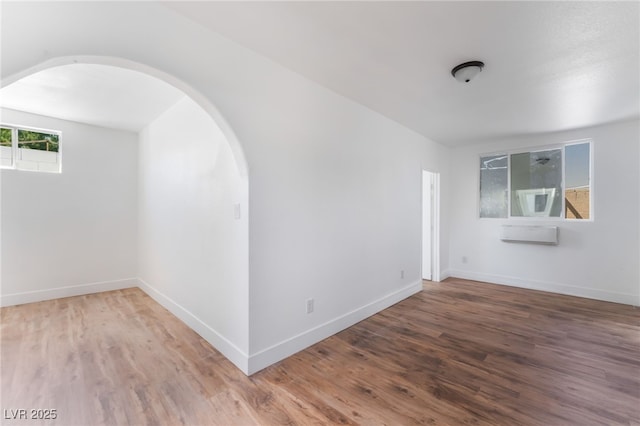 517 N 22nd St, Las Vegas, NV 89101 - unfurnished room with arched walkways, wood finished floors, and baseboards