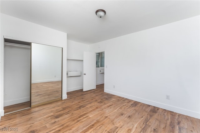 517 N 22nd St, Las Vegas, NV 89101 - unfurnished bedroom with light wood-type flooring, baseboards, and a closet