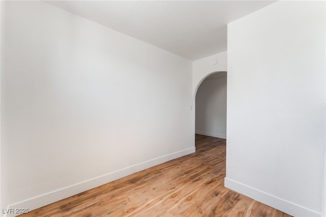 517 N 22nd St, Las Vegas, NV 89101 - spare room with arched walkways, baseboards, and light wood finished floors