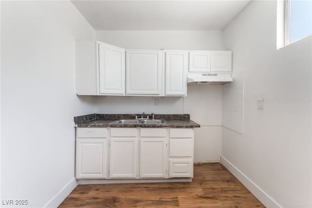 517 N 22nd St, Las Vegas, NV 89101 - kitchen with a sink, under cabinet range hood, dark countertops, and white cabinets