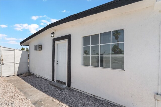 517 N 22nd St, Las Vegas, NV 89101 - doorway to property featuring stucco siding and a wall unit AC