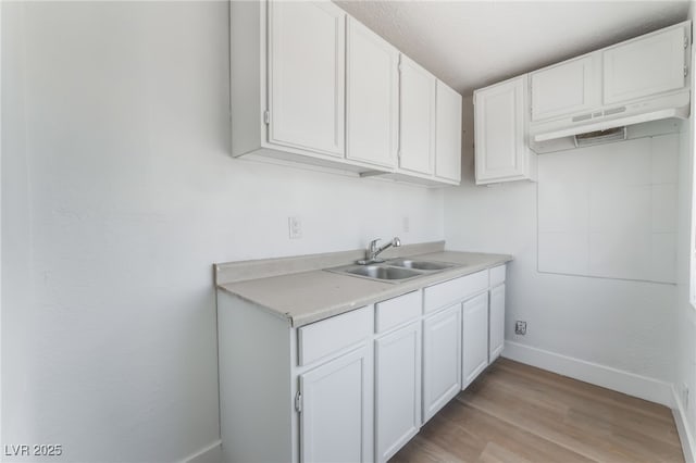 517 N 22nd St, Las Vegas, NV 89101 - kitchen with a sink, light countertops, white cabinets, and baseboards