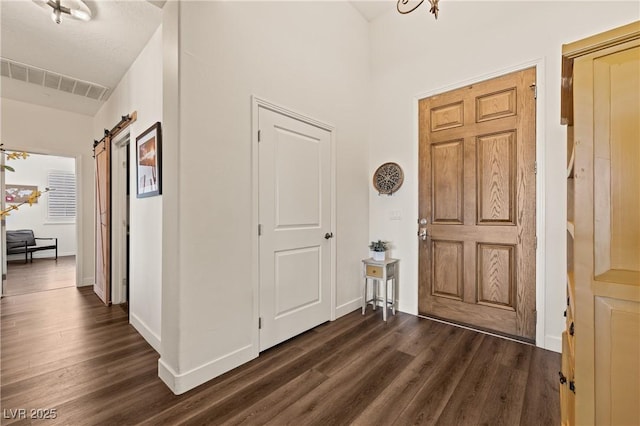 1309 Vista Del Monte Dr, Mesquite, NV 89027 - entryway with dark wood finished floors, a barn door, and baseboards