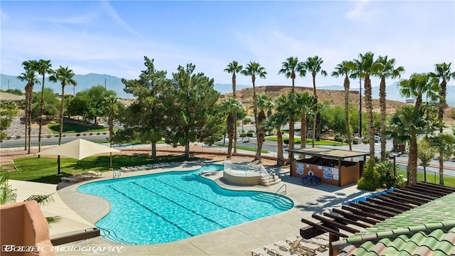 1309 Vista Del Monte Dr, Mesquite, NV 89027 - community pool with a mountain view, a hot tub, and a patio area