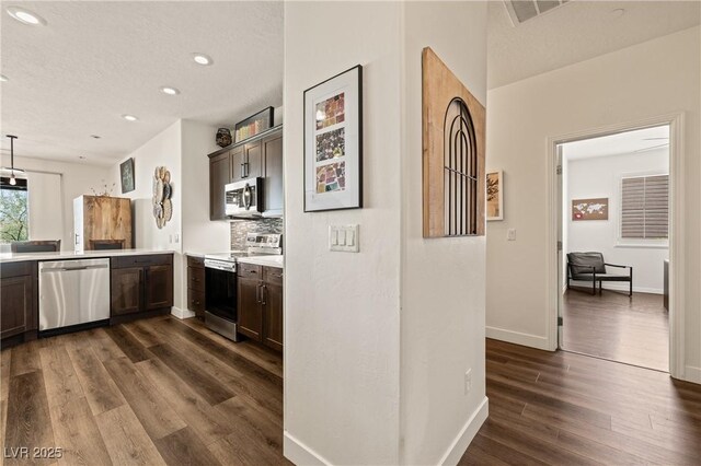 1309 Vista Del Monte Dr, Mesquite, NV 89027 - bar area featuring stainless steel appliances, recessed lighting, dark wood finished floors, baseboards, and decorative backsplash