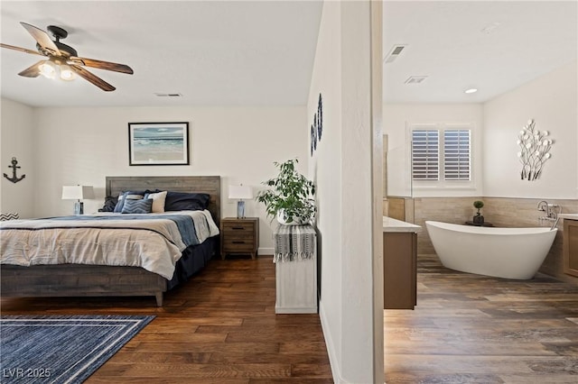 1309 Vista Del Monte Dr, Mesquite, NV 89027 - bedroom featuring wood finished floors, a ceiling fan, and wainscoting