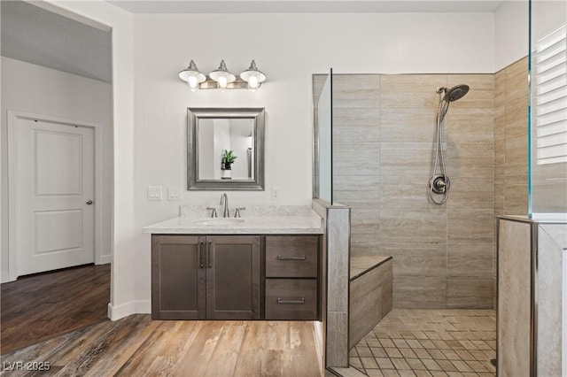 1309 Vista Del Monte Dr, Mesquite, NV 89027 - full bathroom with a walk in shower, vanity, wood finished floors, and baseboards