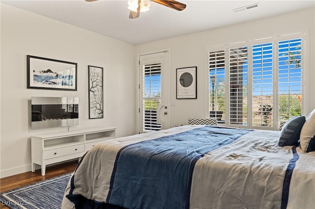 1309 Vista Del Monte Dr, Mesquite, NV 89027 - bedroom featuring access to outside, multiple windows, wood finished floors, and baseboards