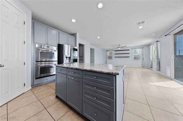 10373 Northern Hills Ave, Las Vegas, NV 89166 - kitchen with appliances with stainless steel finishes, light tile patterned floors, gray cabinetry, a ceiling fan, and recessed lighting