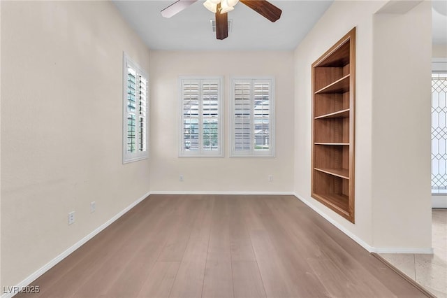 1155 Phillip Island St, Henderson, NV 89052 - unfurnished room featuring a ceiling fan, built in features, and wood finished floors