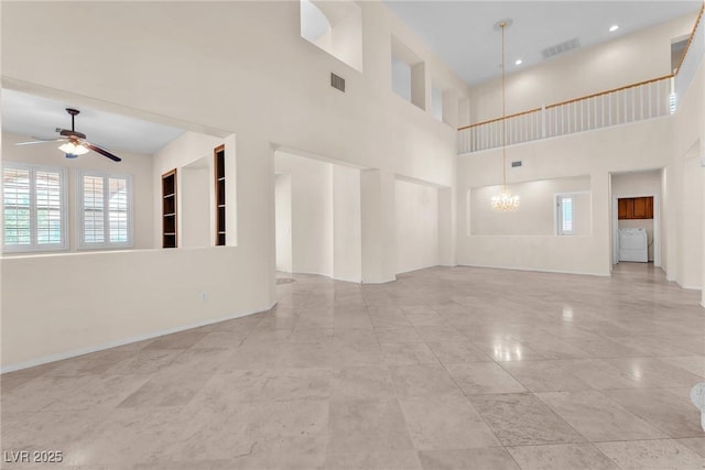 1155 Phillip Island St, Henderson, NV 89052 - unfurnished living room featuring a ceiling fan, a chandelier, healthy amount of natural light, a towering ceiling, and washer / clothes dryer