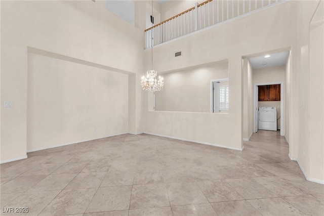 1155 Phillip Island St, Henderson, NV 89052 - tiled spare room with washer / clothes dryer, a chandelier, and a towering ceiling